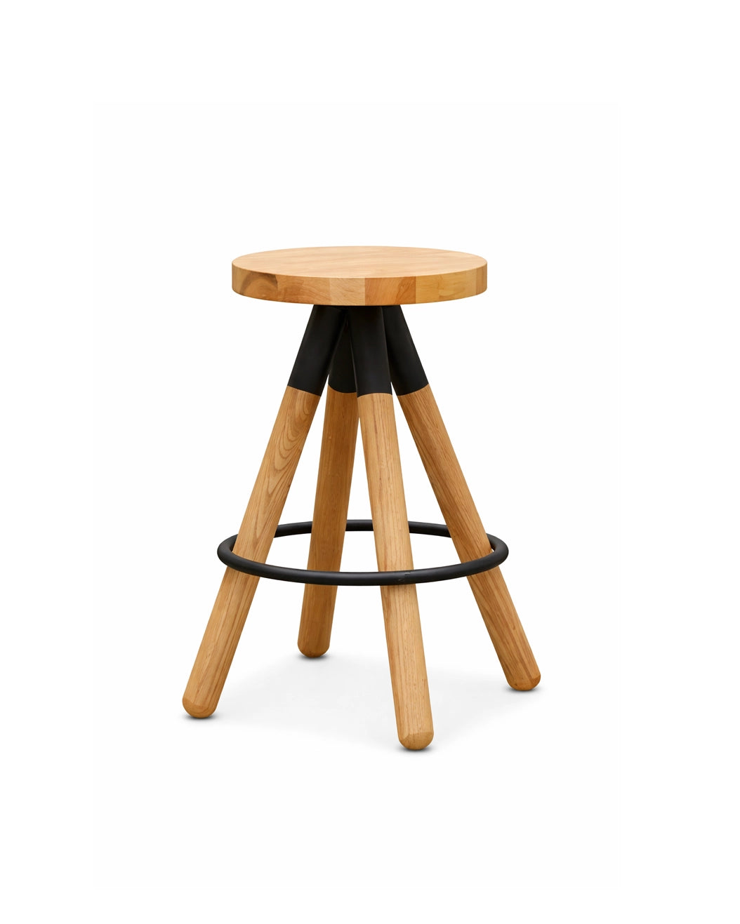 The Blix Counter Stool by SOBU features a round solid American ash seat, four angled legs with black metal brackets, and a circular black footrest. Set against a plain white background.