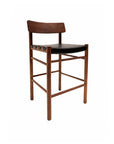 The Cesco Counter Stool - Walnut by SOBU features a curved backrest, black top grain leather seat, and straight American black walnut legs, all set against a plain white background.