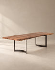A SOBU Leviathan Live Edge Dining Table - Curved Metal Legs featuring a rectangular live-edge acacia wood top set upon two curved black metal legs.