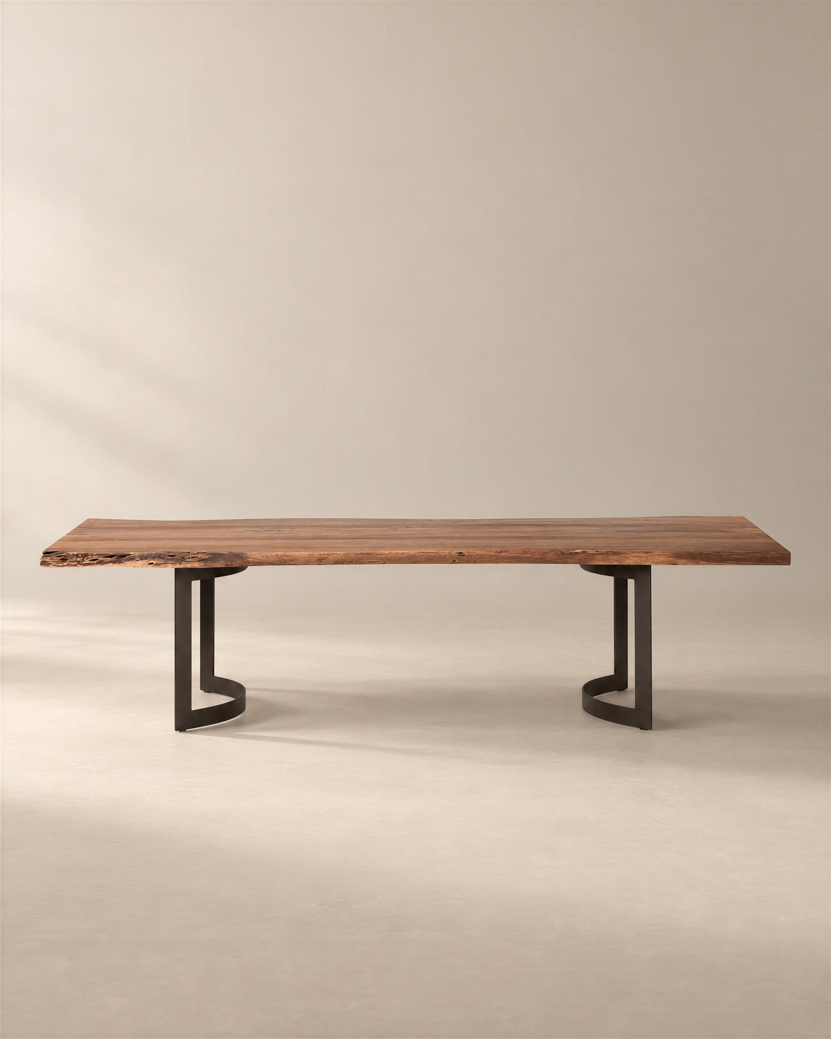 The SOBU Leviathan Live Edge Dining Table - Curved Metal Legs features a long live edge solid acacia top supported by two curved black metal bases.