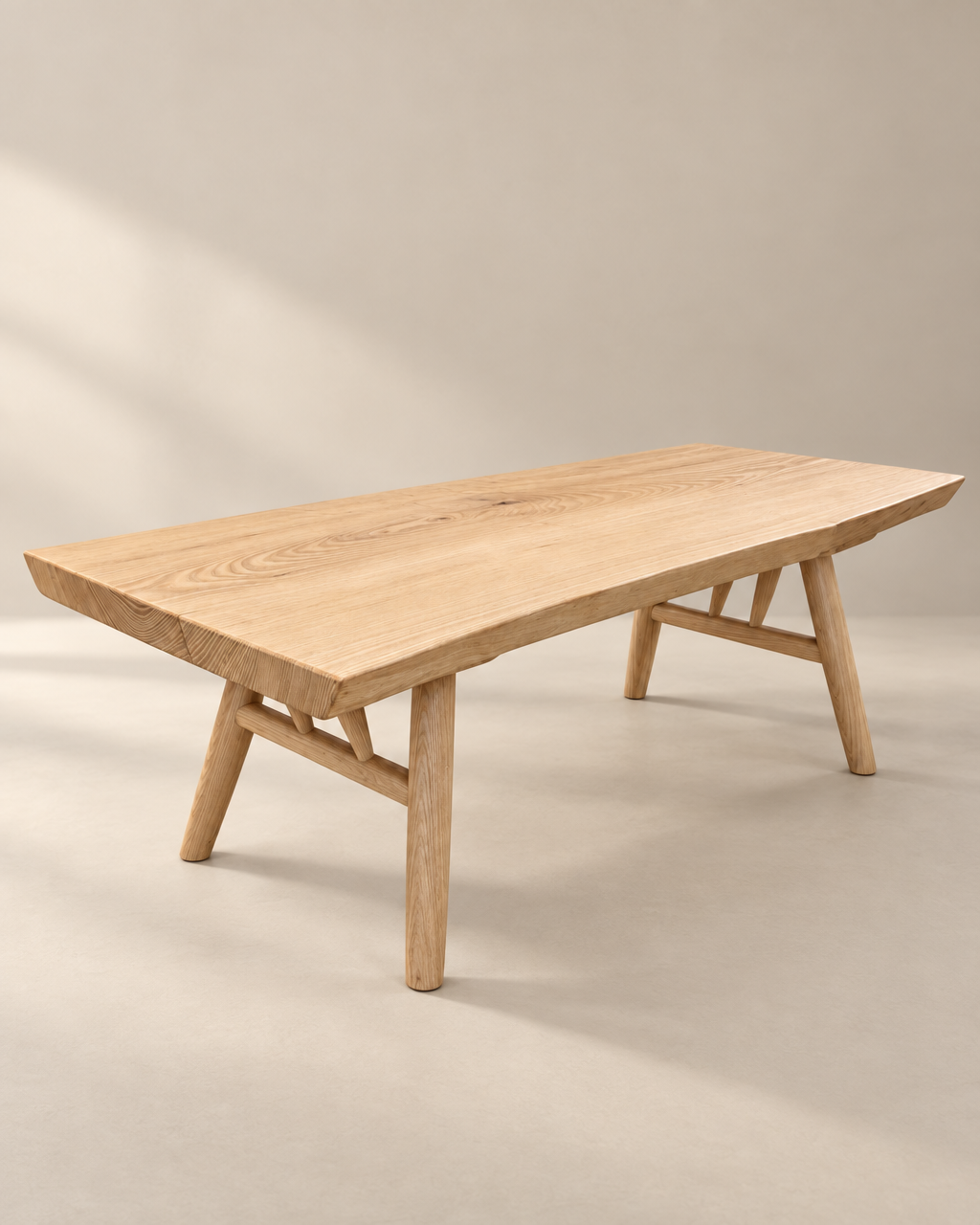 The Mars Live Edge Coffee Table - White Ash by SOBU features a rectangular American ash top and angled legs, set on a neutral floor with a simple, modern design.