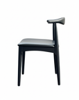 The SOBU Copenhagen Dining Chair in Black Ash features a minimalist design with a curved backrest and four straight legs, crafted from solid wood, shown against a plain white background.