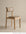 Contract-grade Noki Dining Chair | Leather in light oak featuring a curved, taupe leather backrest and seat.