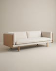 Experience the Sonder Sofa | Fabric with Leather Back by Wooden Stories—a modern Danish-inspired beige sofa featuring clean lines, light wood legs, and soft high-density foam cushions, beautifully showcased against a plain off-white background.