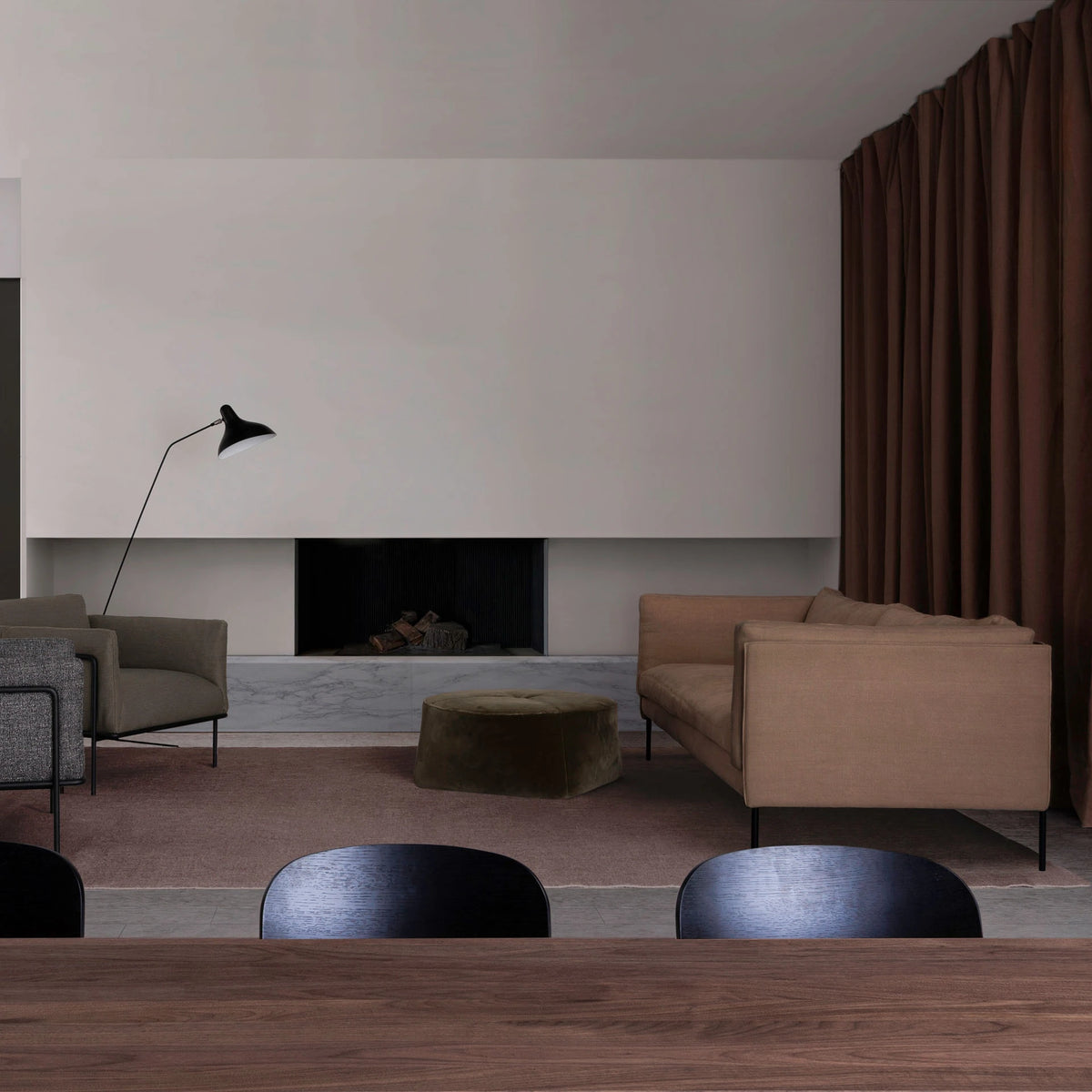A living room with a beige Sonder Sofa | Fabric, two armchairs, a round ottoman, and a fireplace.