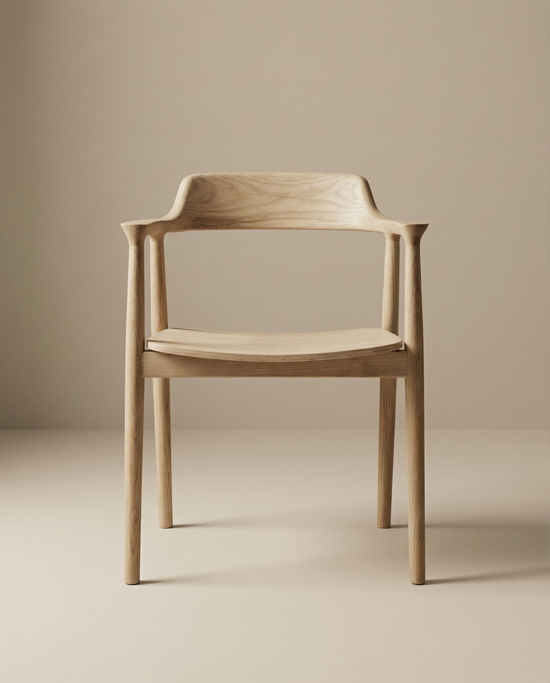The SOBU Sven Dining Chair - White Ash features a minimalist design with curved armrests, crafted from solid American ash. Its smooth lines and light wood grain offer exceptional comfort, shown on a beige surface with a matching background.