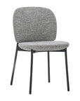 The Solace Dining Chair by Wooden Stories features a cushioned gray fabric seat and backrest, complemented by slim black metal legs for a modern look.