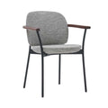 The Solace Dining Armchair | Fabric by Wooden Stories features a gray upholstered seat and backrest, black metal legs, and wooden armrests—a minimalist, contemporary design ideal for modern spaces.