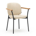 The Solace Dining Armchair | Leather by Wooden Stories features a modern beige upholstered seat and backrest, black metal legs, and wooden armrests, shown against a plain white background.