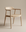 The SOBU Sven Dining Chair - White Ash features a minimalist design with smooth light wood and clean lines, crafted from solid American ash and set against a plain beige background.