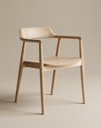 The SOBU Sven Dining Chair - White Ash features a minimalist design with smooth light wood and clean lines, crafted from solid American ash and set against a plain beige background.