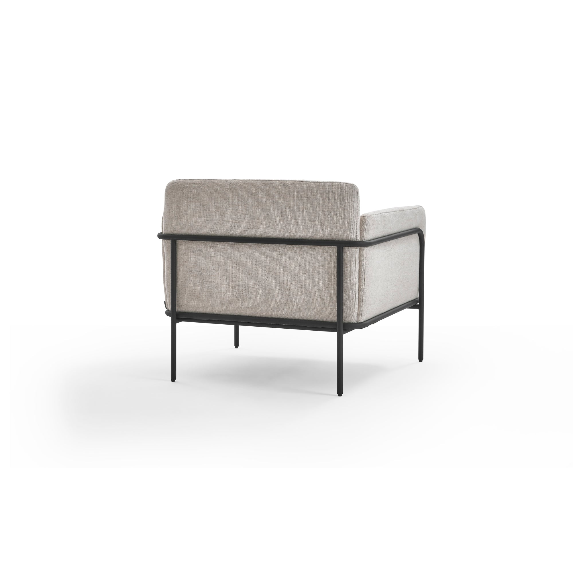 The Scribe Lounge Chair by Wooden Stories features light beige fabric upholstery and a Bauhaus-inspired metal frame, shown from the back against a white background.
