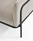 Close-up of the Scribe Lounge Chair | Fabric by Wooden Stories, featuring modern beige upholstery and a Bauhaus-inspired metal frame and legs. The image highlights the chair’s corner and minimalist design against a white background.