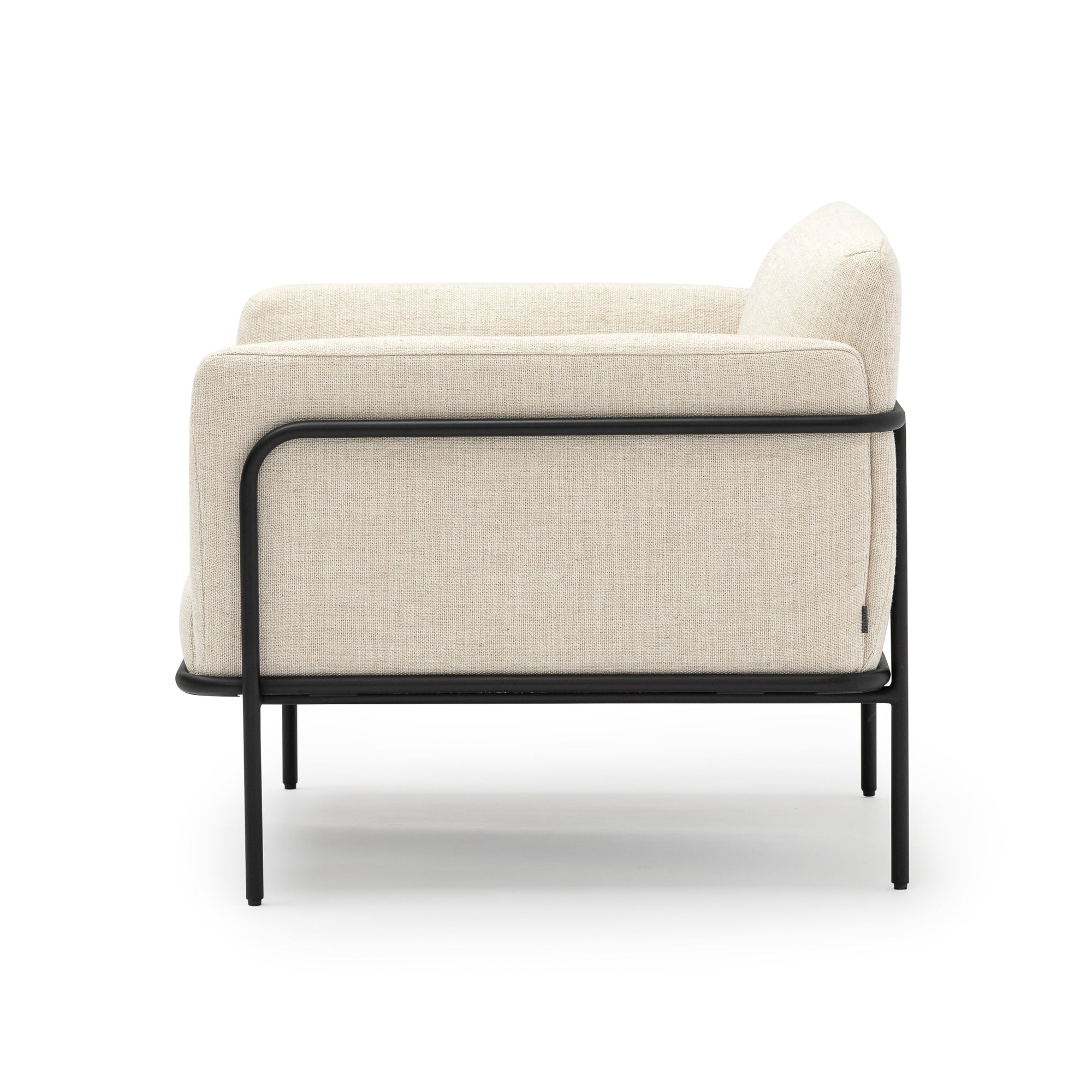 The Scribe Lounge Chair | Fabric by Wooden Stories features modern beige upholstery and a Bauhaus-inspired metal frame, shown from the side against a white background.