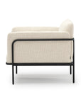 The Scribe Lounge Chair | Fabric by Wooden Stories features modern beige upholstery and a Bauhaus-inspired metal frame, shown from the side against a white background.