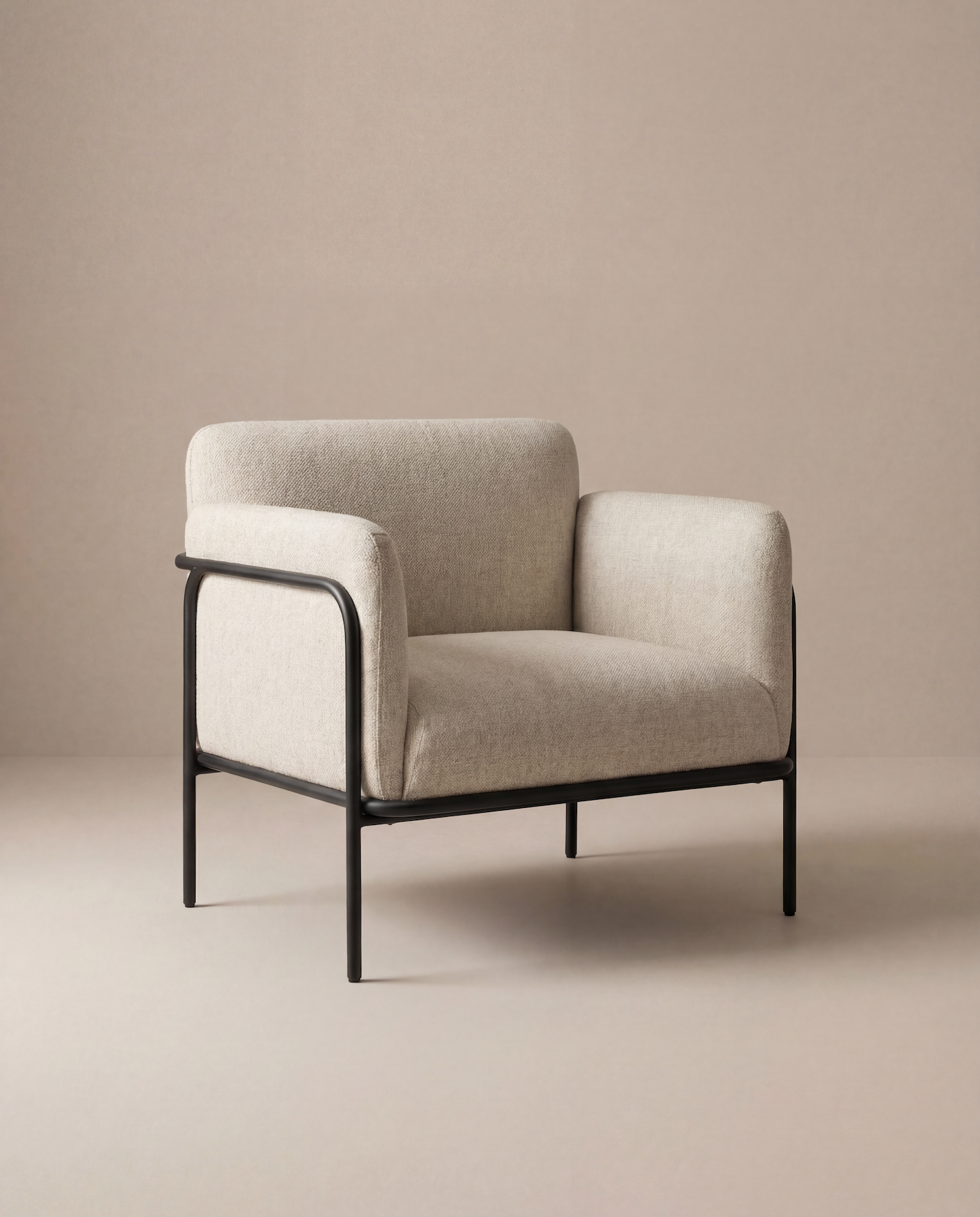 The Scribe Lounge Chair | Fabric by Wooden Stories features a Bauhaus-inspired beige design with a minimalist black metal frame and soft upholstery, set against a light beige background to embody contemporary style.