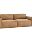 The Baker Sofa | Leather by Wooden Stories features a modern, light brown design with wide armrests and plush back cushions, set against a white background—ideal for any contemporary furniture space.