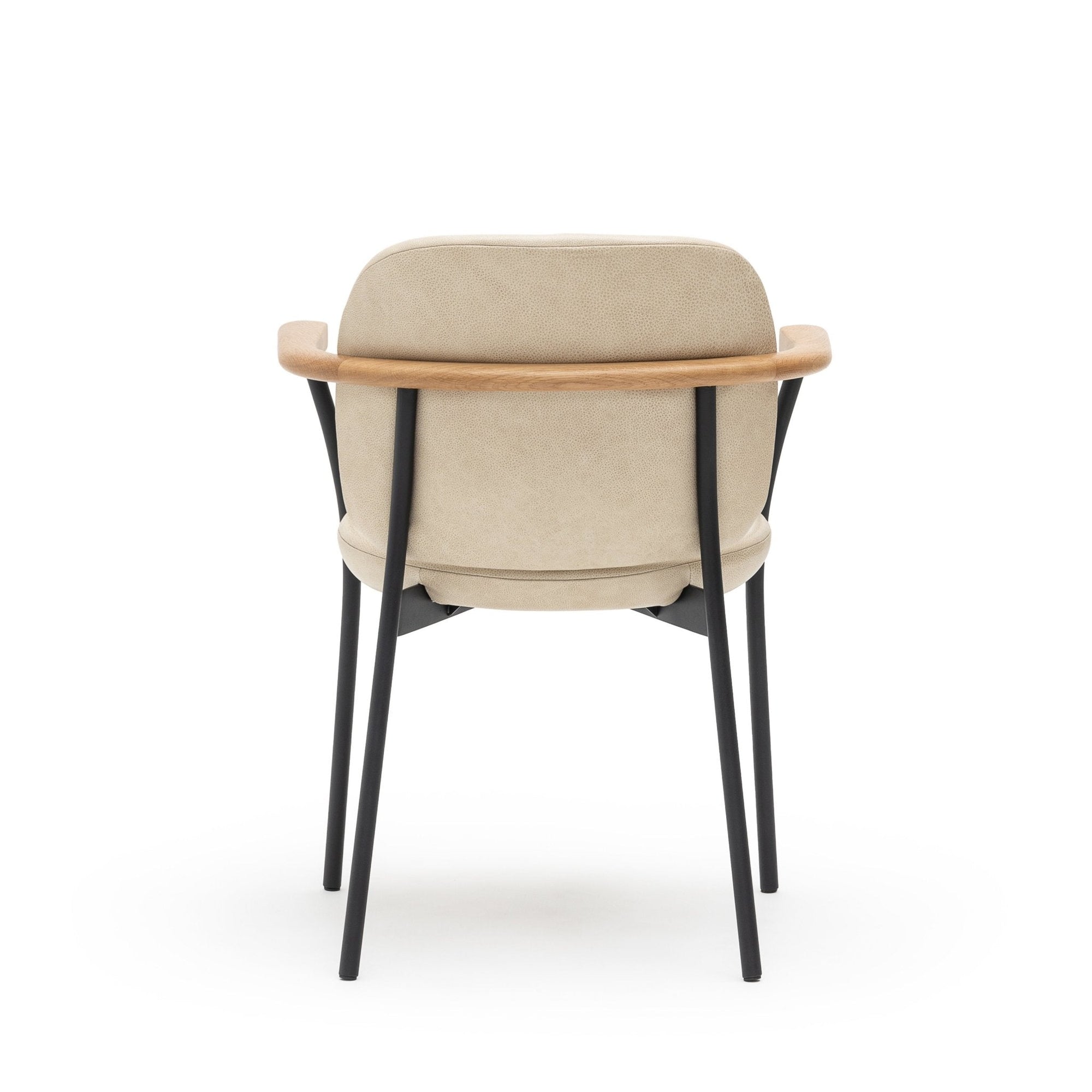 The Solace Dining Armchair by Wooden Stories features a modern beige leather upholstery, curved wooden backrest, and black metal legs, shown from the back against a white background.