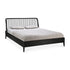 The Spindle Bed - Black Oak by Ethnicraft, made from solid European oak with a spindle headboard, is shown with a light gray mattress and two matching pillows on a white background.