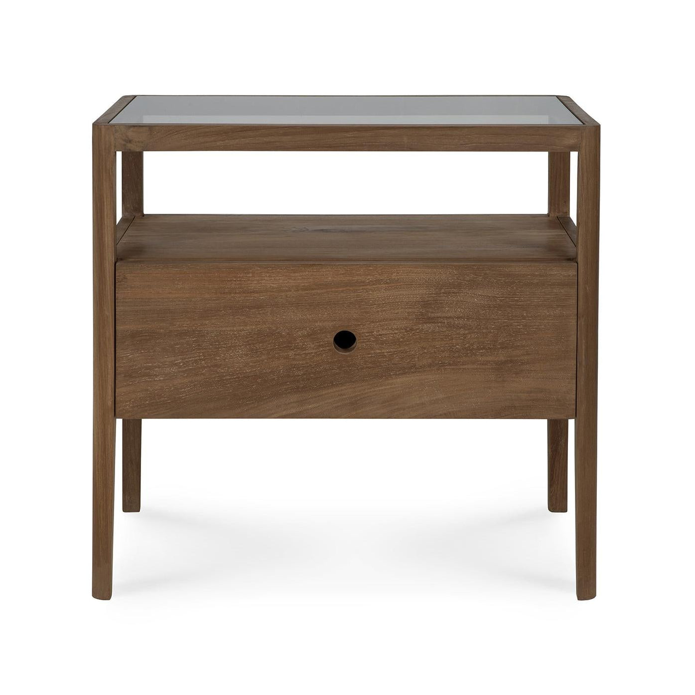 The Spindle Nightstand - Teak by Ethnicraft is crafted from FSC-certified teak and features four legs, a glass top, an open shelf, and a single drawer with a round hole handle.