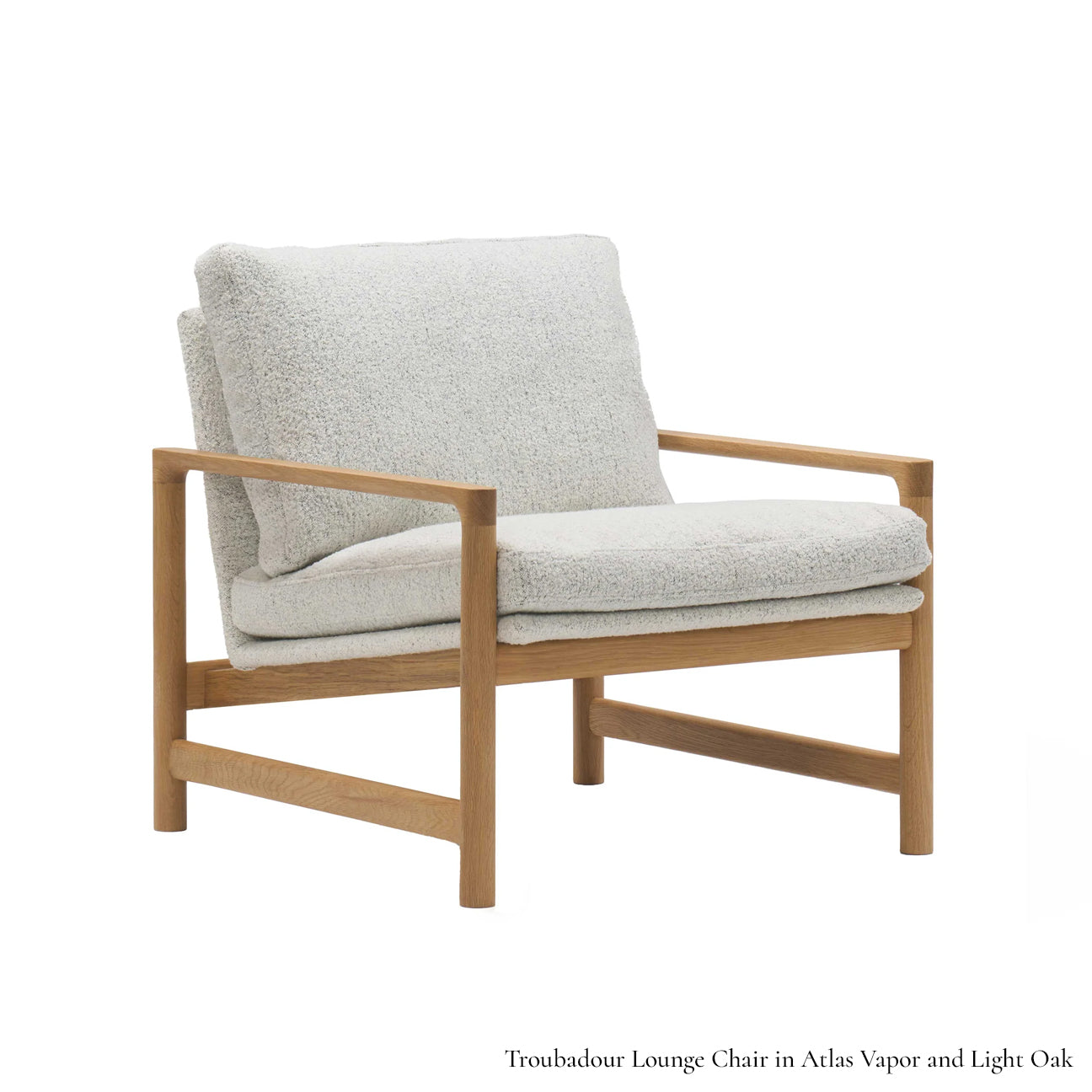 The Troubadour Lounge Chair | Fabric by Wooden Stories features a solid oak frame, plush white cushions, clean lines, and minimalist design inspired by Danish collections for a modern mid-century look.