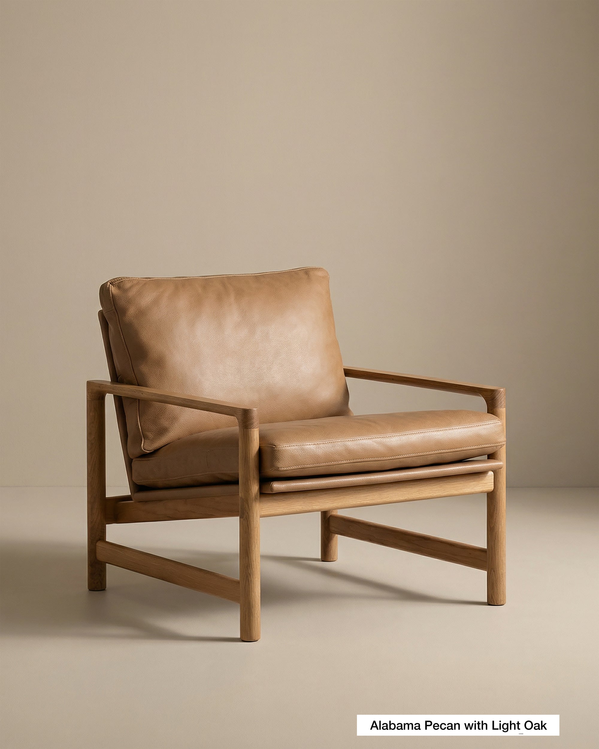 A modern Troubadour Lounge Chair | Leather by Wooden Stories, featuring a light oak wood frame and tan leather cushions, is set against a beige background. A small label at the bottom right reads Alabama Pecan with Light Oak.