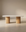 The Tathra Ellipse Dining Table by Wooden Stories features a smooth oval stone top and twin cylindrical wooden bases, exemplifying European craftsmanship and modern design—perfect for minimalist, neutral-toned spaces.