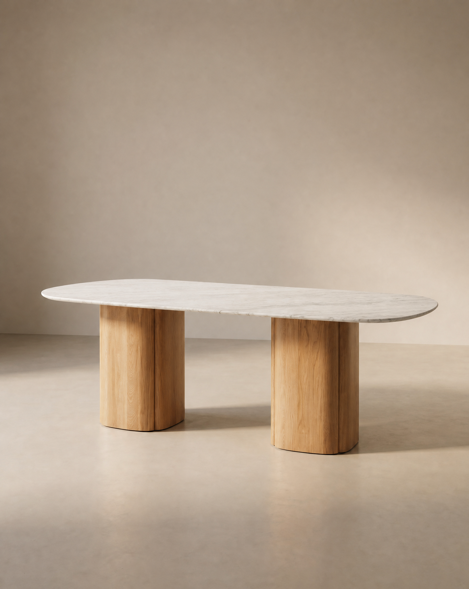The Tathra Ellipse Dining Table by Wooden Stories features an oval stone top and two solid oak pedestal legs, highlighting European craftsmanship, set against a neutral beige background.