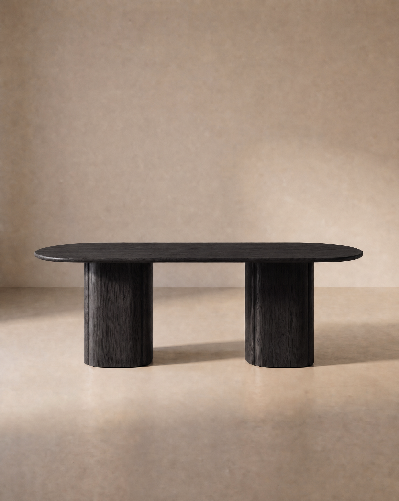 A modern oak Tathra Ellipse Dining Table by Wooden Stories, featuring two cylindrical pedestal legs, sits in a neutral, softly lit room with a plain beige background, embodying the timeless elegance of Danish design.