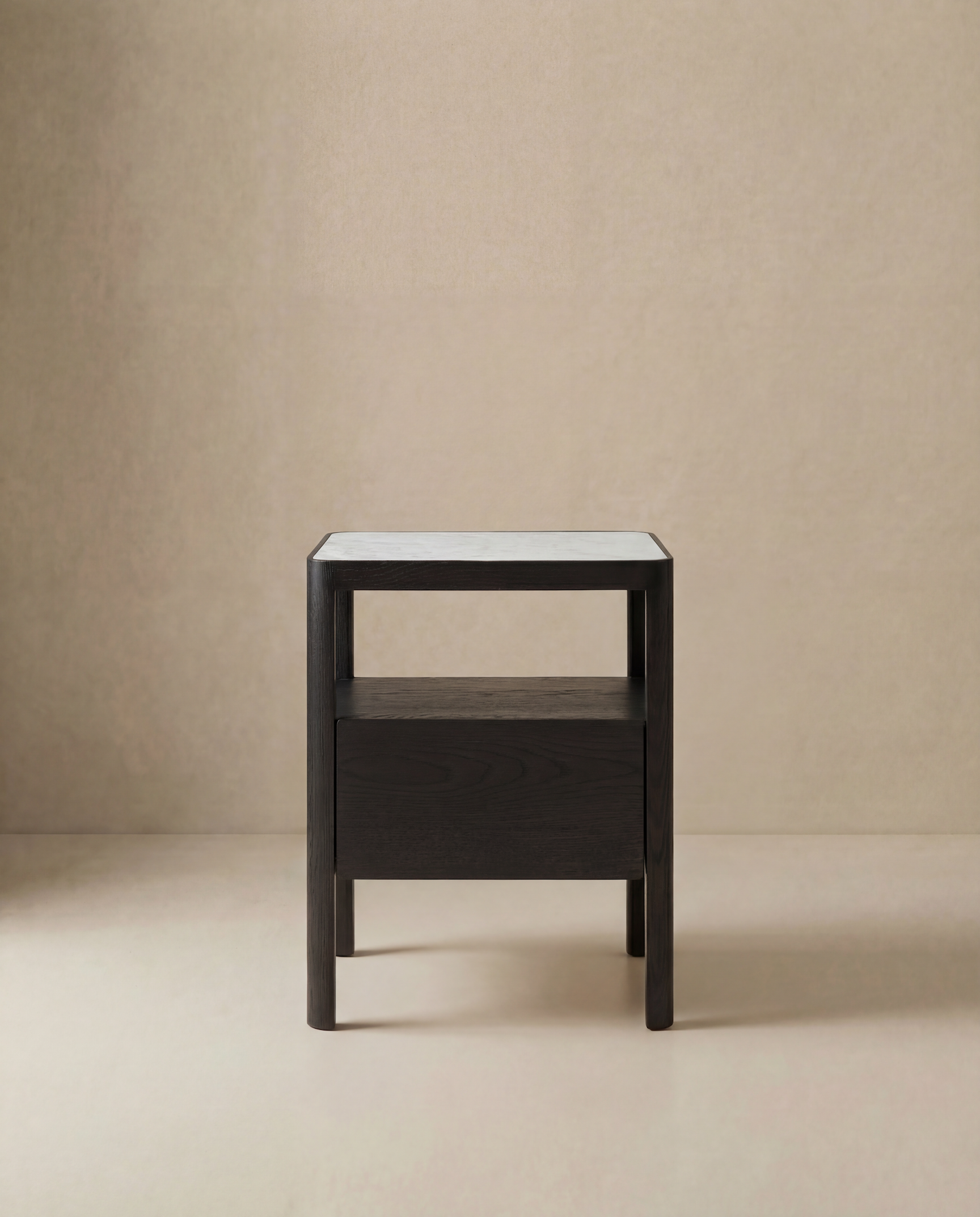 The Theo Nightstand by Wooden Stories is a minimalist wooden side table with Danish-inspired lines, a dark finish, rectangular shape, open shelf, and light top, shown against a beige background.