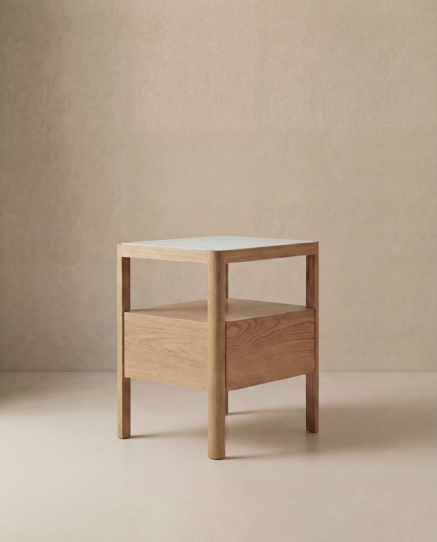 The Theo Nightstand by Wooden Stories is a modern wood side table with Danish lines, featuring a square marble top and one drawer, shown on a neutral beige background.