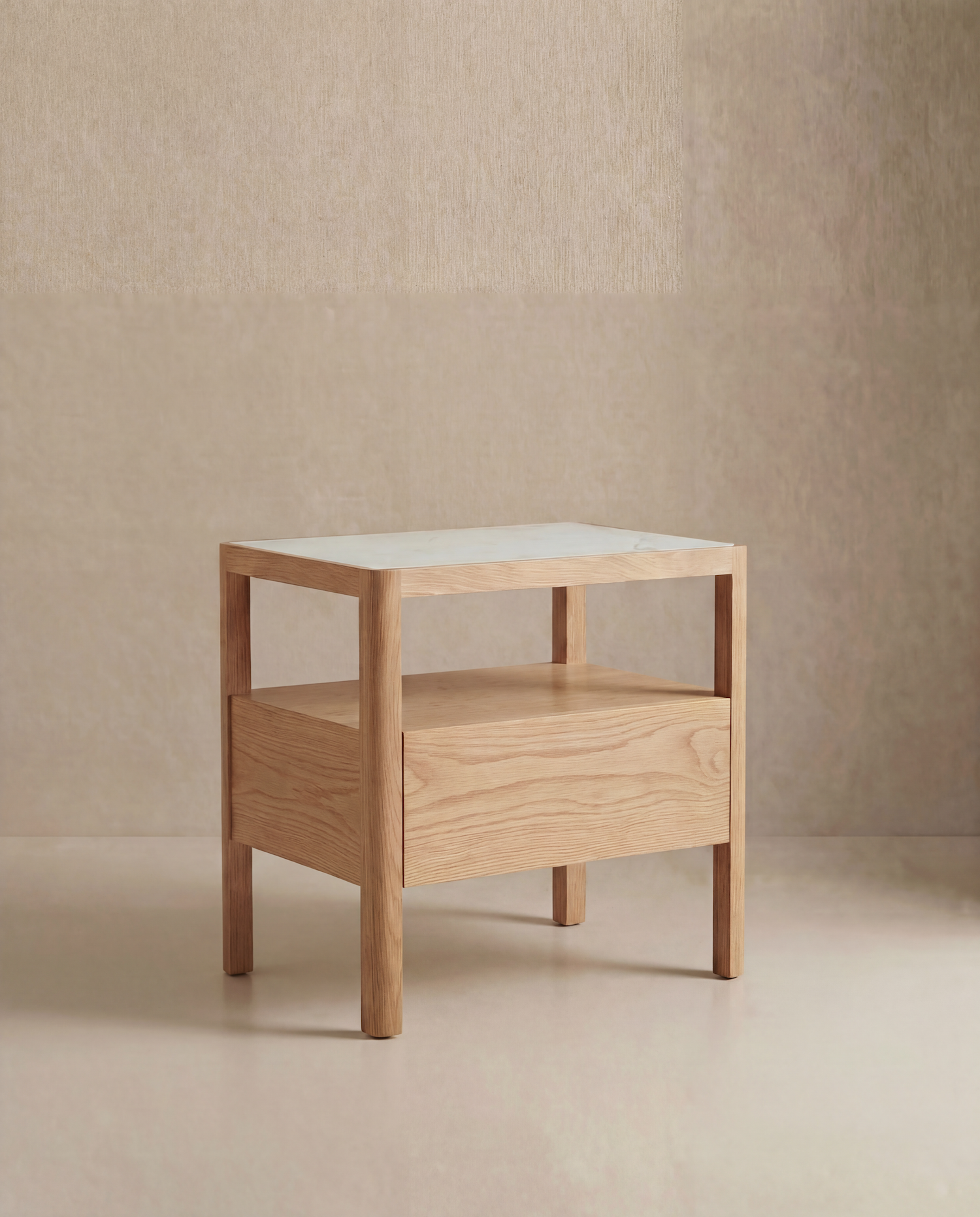 The Theo Nightstand Wide by Wooden Stories is a modern wood side table with Danish lines, a rectangular white top, single drawer, and four square legs, shown against a neutral beige textured wall and floor.