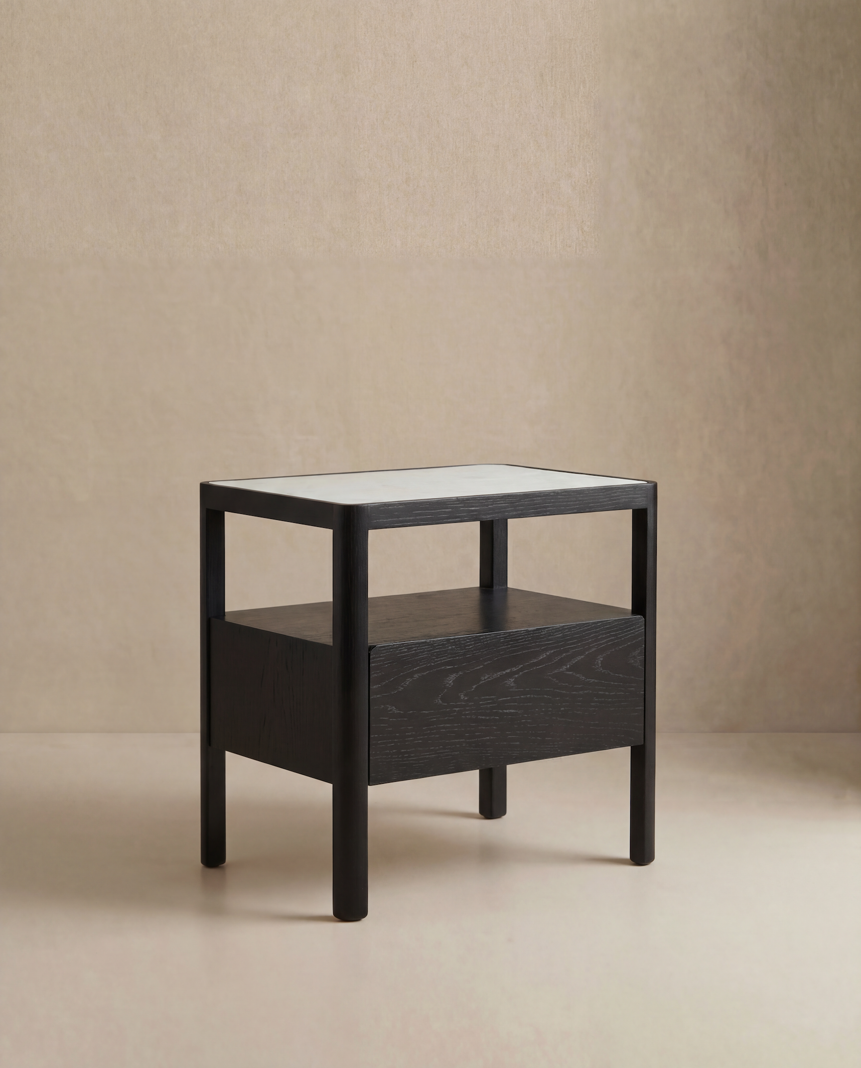 The Theo Nightstand Wide by Wooden Stories is a modern, minimalist black wooden side table featuring clean Danish lines, a rectangular top, and an open shelf, shown against a neutral beige background.