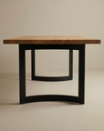 The SOBU Tommaso Dining Table features a modern European oak top and curved black metal legs, set against a plain, light-colored background.