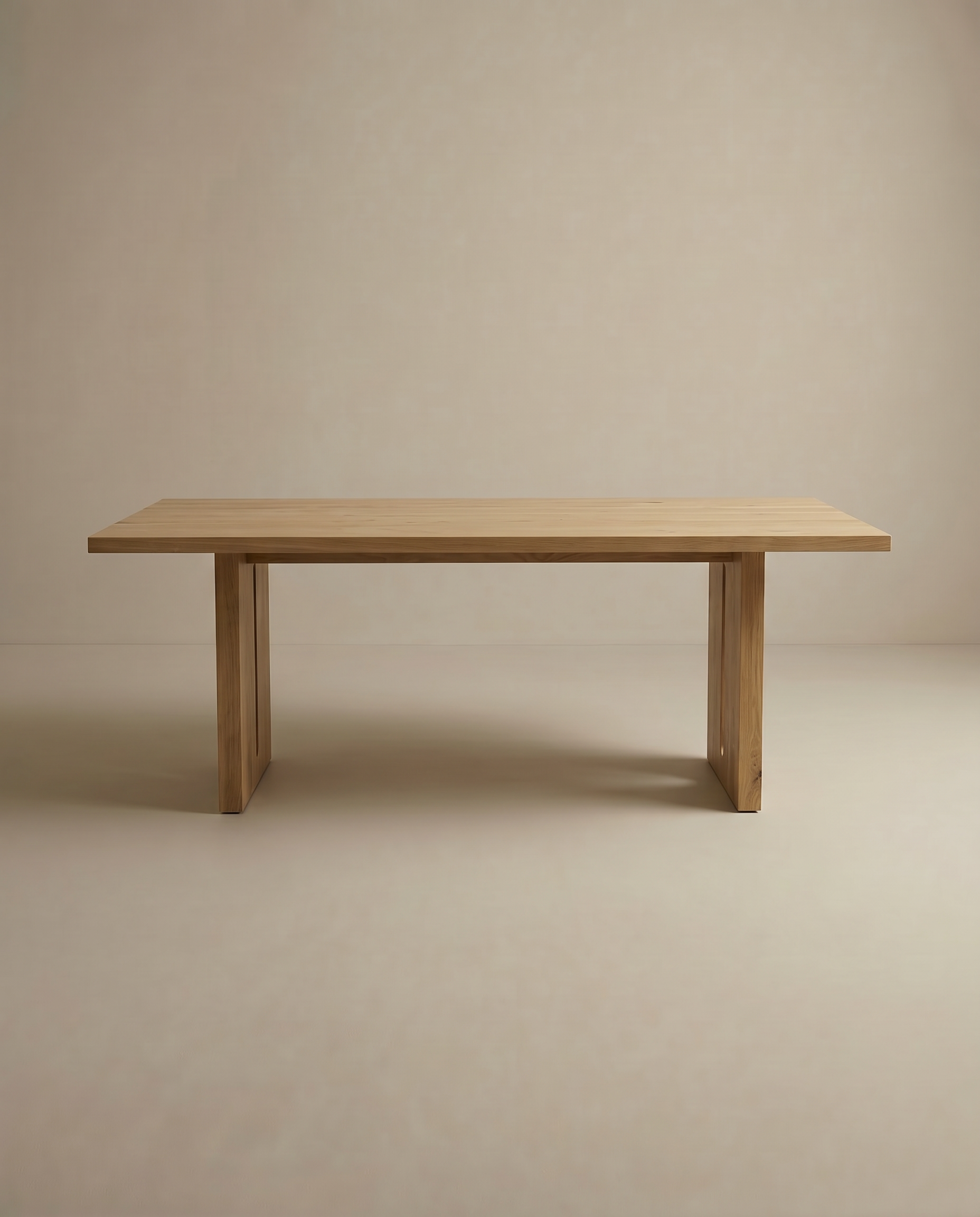 The Tommaso Dining Table by SOBU features a rectangular solid wood top, clean lines, and two sturdy wood legs, designed for durability and shown against a plain light beige background.
