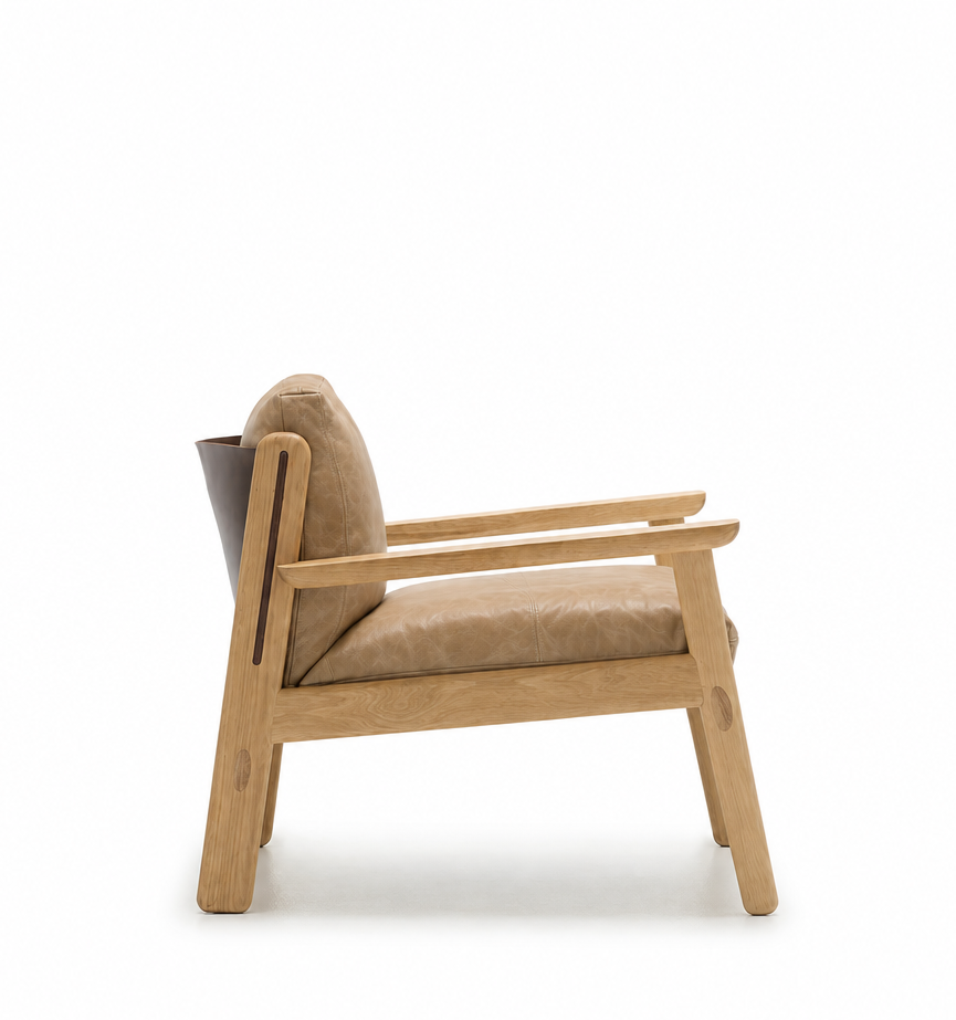 Side view of the Wren Lounge Chair | Leather by Wooden Stories, featuring a light wood frame and tan cushioned seat and backrest upholstered in Sørensen Harness leather, photographed against a plain white background.