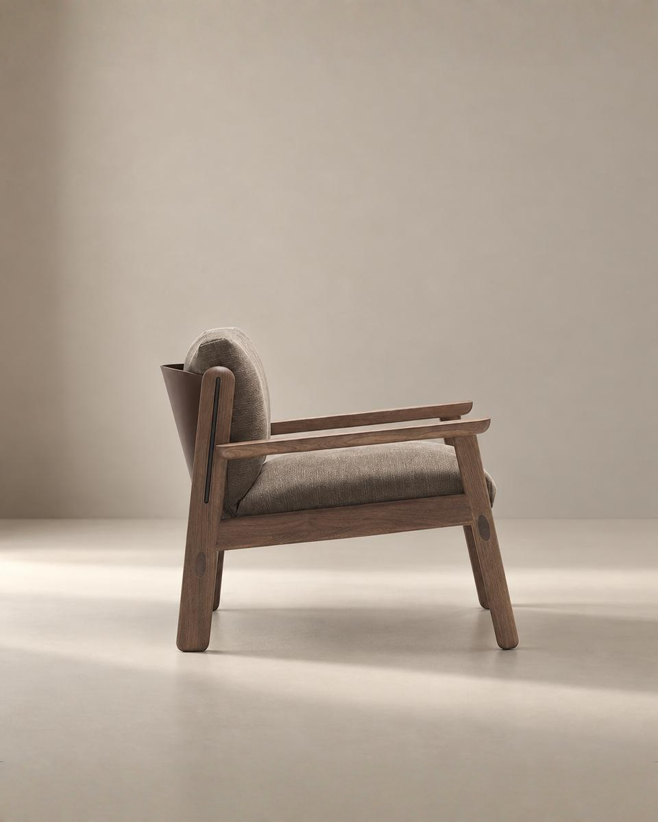 The Wren Lounge Chair | Fabric by Wooden Stories is a modern wooden armchair inspired by Danish design, featuring a light brown cushioned seat and backrest crafted from solid walnut, photographed from the side against a neutral beige background.