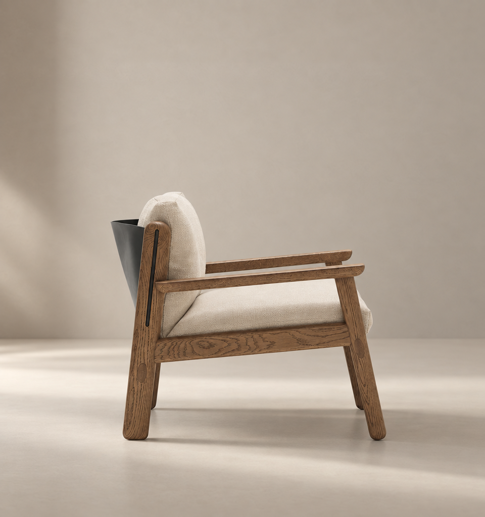 A modern wooden armchair—the Wren Lounge Chair | Fabric by Wooden Stories—crafted from solid walnut with light beige cushions and a black accent on the backrest, is placed on a light-colored floor against a plain beige background, embodying timeless Danish furniture design.