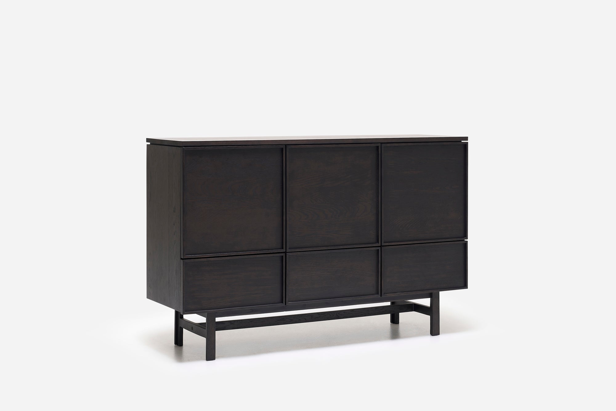 The Yorke Highboard by Wooden Stories is a modern dark wood sideboard with six flat panel doors and four legs connected by a horizontal support bar, inspired by Scandinavian design and shown against a plain white background.