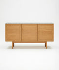 The Yorke Sideboard with Stone Top by Wooden Stories features Danish-inspired lines and three panel doors, topped with white stone, shown against a plain white background.