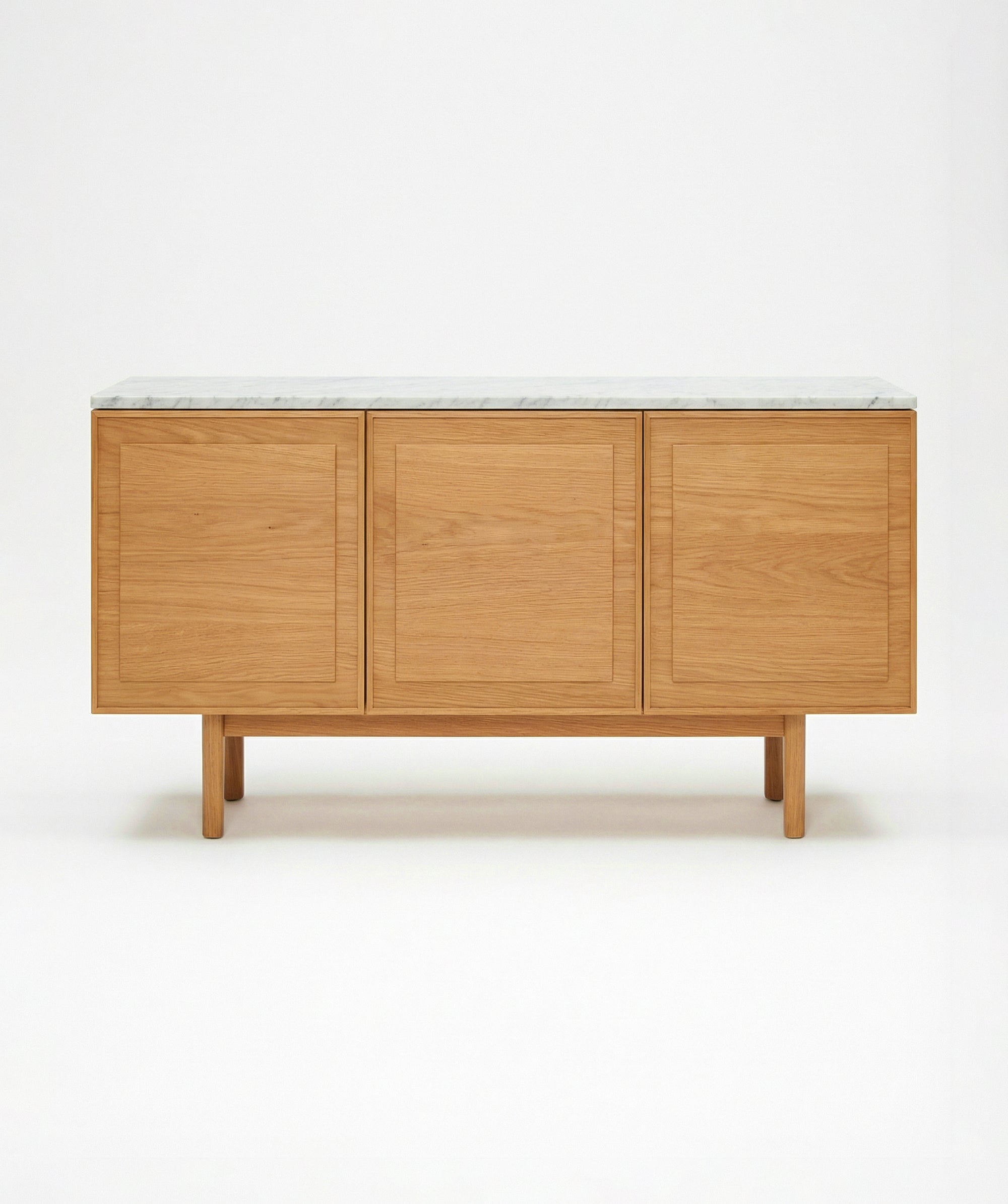 The Yorke Sideboard with Stone Top by Wooden Stories features Danish-inspired lines and three panel doors, topped with white stone, shown against a plain white background.
