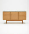 The Yorke Sideboard with Stone Top by Wooden Stories features Danish-inspired lines and three panel doors, topped with white stone, shown against a plain white background.
