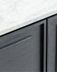 Close-up of the Wooden Stories Yorke Sideboard with Stone Top. Its gray finish, visible wood grain, and flat-panel design offer sleek Danish lines for a minimalist, contemporary look.