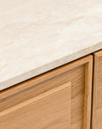 Close-up of the Wooden Stories Yorke Sideboard with Stone Top, featuring a light stone surface and natural-finish cabinetry with simple rectangular paneling.