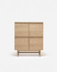 The Yorke Highboard by Wooden Stories is a light wood Scandinavian storage cabinet featuring four panel doors and a simple rectangular design, standing on a matching wooden base against a plain white background.