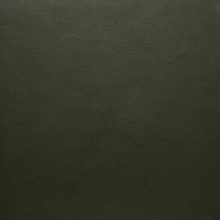 Close-up of dark green, textured leather with a fine pebbled grain, featured in Wooden Stories&#39; Fabric + Leather Swatches collection, shown under even lighting to highlight its flawless, custom made-to-order finish.