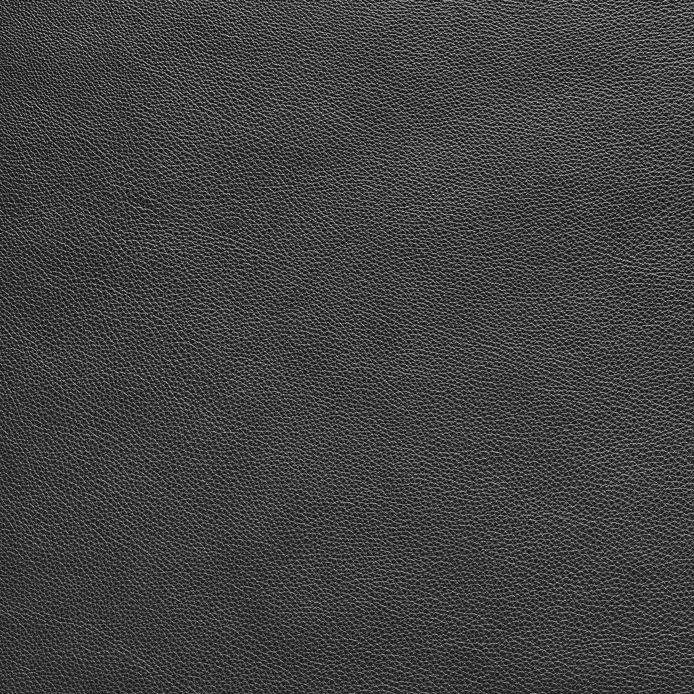 Close-up of a black leather surface with fine natural grain, featured in Wooden Stories&#39; Fabric + Leather Swatches. The smooth, durable texture and subtle sheen make it ideal for custom made-to-order pieces.