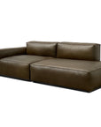 The Baker Modular Sofa | Leather • M1 by Wooden Stories is a modern, dark brown sectional with wide seats, low armrests, and plush back cushions. Its clean lines and contemporary style stand out against a white background.