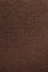 Close-up of a textured brown surface with small granules, evoking the vintage vibe found in Ethnicraft’s Barrow Lounge Chair - Copper.