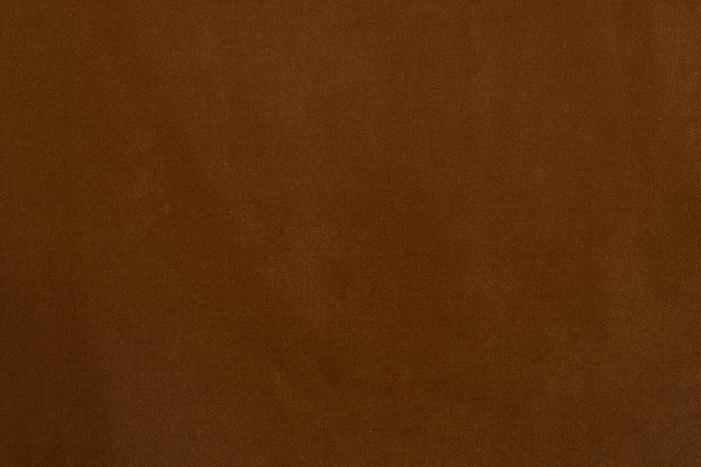 A smooth, solid brown fabric texture fills the image, creating a uniform surface with subtle shading and no visible patterns—perfect for custom Fabric + Leather Swatches from Wooden Stories.